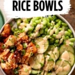 A rice bowl topped with glazed salmon, edamame, sliced cucumbers, and a creamy drizzle, with the text Salmon Rice Bowls at the top.
